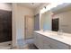 A modern bathroom features dual sinks, stylish fixtures, and tile flooring at 2205 Gathering Square Ct, Fuquay Varina, NC 27526