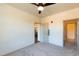 An open bedroom features neutral carpet, a ceiling fan, and multiple closets for great storage at 2205 Gathering Square Ct, Fuquay Varina, NC 27526