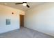 An inviting bedroom features neutral carpet, a ceiling fan, and a closet for ample storage at 2205 Gathering Square Ct, Fuquay Varina, NC 27526