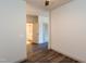 Hallway view leading to a bathroom and bedroom with hardwood floors and neutral paint at 2205 Gathering Square Ct, Fuquay Varina, NC 27526