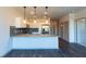 Well-lit kitchen with white cabinets, stainless appliances, granite counters, and dark wood flooring at 2205 Gathering Square Ct, Fuquay Varina, NC 27526