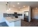 Modern kitchen features white cabinets, stainless steel appliances, and a granite countertop island at 2205 Gathering Square Ct, Fuquay Varina, NC 27526
