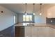 Open concept kitchen with stainless steel dishwasher and granite countertop island overlooking the living area at 2205 Gathering Square Ct, Fuquay Varina, NC 27526