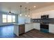 Bright kitchen with granite countertops, stainless steel appliances, and sleek cabinetry at 2205 Gathering Square Ct, Fuquay Varina, NC 27526