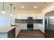 Modern kitchen with granite countertops, stainless steel appliances, and ample cabinet space at 2205 Gathering Square Ct, Fuquay Varina, NC 27526