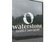 Waterstone Gathering Dentistry sign shows the business logo on a window at 2205 Gathering Square Ct, Fuquay Varina, NC 27526