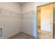 Spacious walk-in closet with ample storage shelving and an open doorway for easy access at 2205 Gathering Square Ct, Fuquay Varina, NC 27526