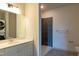 Bathroom featuring tiled walk-in shower, laundry, and a vanity at 2316 Gathering Square Ct, Fuquay Varina, NC 27526