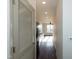 Hallway view leading to kitchen with ample natural light and hardwood floors at 2316 Gathering Square Ct, Fuquay Varina, NC 27526