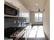 Modern kitchen featuring stainless steel appliances, granite countertops, and ample cabinetry at 2316 Gathering Square Ct, Fuquay Varina, NC 27526