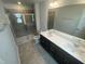Bathroom with double vanity, white countertop, and tiled shower enclosed with a glass door at 247 Paramount Dr # 104, Smithfield, NC 27577