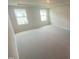 Spacious bedroom with neutral carpet, plenty of natural light from two windows, and ample space at 247 Paramount Dr # 104, Smithfield, NC 27577