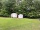 View of two storage sheds in a spacious backyard at 284 Irvan St, Clayton, NC 27520