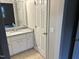 Bathroom with granite vanity, white cabinets, and neutral paint at 284 Irvan St, Clayton, NC 27520
