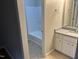 Bathroom features a white tub/shower combo, tile flooring, and granite vanity at 284 Irvan St, Clayton, NC 27520