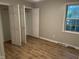 Bedroom boasts wood-look floors, fresh paint, a window, and a closet with bi-fold doors at 284 Irvan St, Clayton, NC 27520