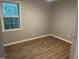 Bedroom featuring wood-look floors, fresh paint, and a window providing plenty of natural light at 284 Irvan St, Clayton, NC 27520