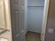 Walk-in closet featuring a wooden rod for hanging clothes and neutral tile flooring at 284 Irvan St, Clayton, NC 27520
