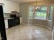 Updated kitchen with white cabinets, dark appliances, and bay window nook for dining at 284 Irvan St, Clayton, NC 27520