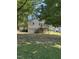 View of the backyard with a deck and stairs to the upper level of the home and trees surrounding it at 304 Culvert St, Apex, NC 27502