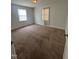 Bright bedroom featuring two windows, carpet flooring, and ample space at 304 Culvert St, Apex, NC 27502