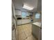 Functional kitchen equipped with appliances, tile floor, and ample counter space at 304 Culvert St, Apex, NC 27502