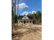New home featuring a covered porch and surrounded by lush trees at 328 Green Pines Estates Dr, Kenly, NC 27542
