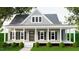 Charming home with a covered porch, black shutters, and well-manicured landscaping at 328 Green Pines Estates Dr, Kenly, NC 27542