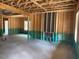View of the interior of a new home construction with exposed wood framing and concrete floors at 328 Green Pines Estates Dr, Kenly, NC 27542