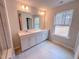 Bathroom featuring double sink vanity, large mirror and a window for natural light at 355 Beacon Hill Rd # 23, Lillington, NC 27546