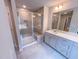 Bathroom featuring tiled shower with glass door, large mirror and vanity with sink at 355 Beacon Hill Rd # 23, Lillington, NC 27546