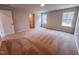 An upstairs bedroom with natural light, neutral carpet, and a walk-in closet at 355 Beacon Hill Rd # 23, Lillington, NC 27546