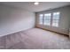 Bedroom with plush carpet, three windows, and neutral wall paint at 355 Beacon Hill Rd # 23, Lillington, NC 27546