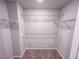 Walk-in closet featuring carpet and multiple white wire shelves for ample storage at 355 Beacon Hill Rd # 23, Lillington, NC 27546