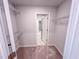Carpeted walk-in closet with white shelving and view to hallway and bathroom at 355 Beacon Hill Rd # 23, Lillington, NC 27546