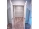Carpeted closet interior with white walls, shelving, and double doors at 355 Beacon Hill Rd # 23, Lillington, NC 27546