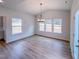 Dining Room with hardwood floors, three windows, and a modern light fixture at 355 Beacon Hill Rd # 23, Lillington, NC 27546