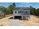 New construction with a modern design, visible garage, and covered front porch at 355 Beacon Hill Rd # 23, Lillington, NC 27546