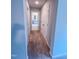 Hallway with carpeted floor leading to a bathroom with dual sinks and a large mirror at 355 Beacon Hill Rd # 23, Lillington, NC 27546