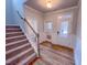 Hallway with wood-look floors, featuring a staircase and a view of the front door at 355 Beacon Hill Rd # 23, Lillington, NC 27546