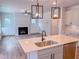An open-concept kitchen with stainless steel appliances and a sink-equipped island at 355 Beacon Hill Rd # 23, Lillington, NC 27546