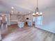 Open floorplan of kitchen featuring hardwood floors, an island, and modern light fixtures at 355 Beacon Hill Rd # 23, Lillington, NC 27546