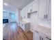 Bright, open kitchen with white cabinets, stainless appliances, and a subway tile backsplash at 355 Beacon Hill Rd # 23, Lillington, NC 27546