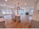Bright, open kitchen with an island, white cabinets, stainless appliances and hardwood flooring at 355 Beacon Hill Rd # 23, Lillington, NC 27546