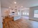 Open floorplan of kitchen featuring hardwood floors, an island, and modern light fixtures at 355 Beacon Hill Rd # 23, Lillington, NC 27546