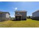 Backyard view of the screened-in porch and lush lawn at 3629 Brittlebank Dr, Raleigh, NC 27610