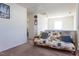 Bright bedroom area featuring a futon with decorative pillows and access to other rooms at 3629 Brittlebank Dr, Raleigh, NC 27610