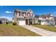 Charming two-story home featuring a front-facing garage, red shutters, and well-maintained landscaping at 3629 Brittlebank Dr, Raleigh, NC 27610