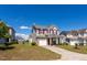 Beautiful two-story home featuring red shutters, a front-facing garage, and professionally landscaped yard at 3629 Brittlebank Dr, Raleigh, NC 27610