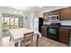 Cozy kitchen with stainless steel appliances, wooden cabinets, and an eat-in dining area at 3629 Brittlebank Dr, Raleigh, NC 27610
